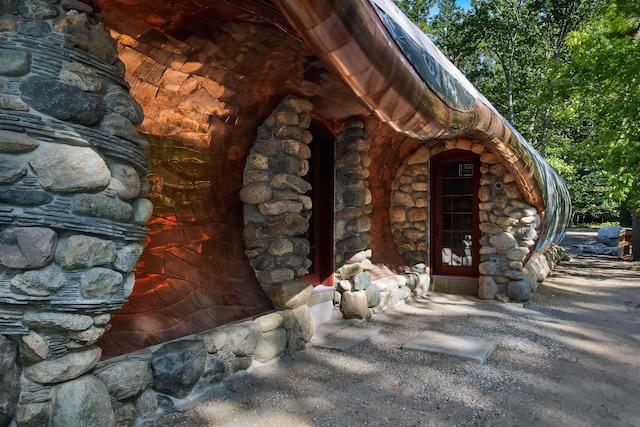 9554 Fowler Ln, Rapid City, MI 49676 - view of exterior entry with stone siding