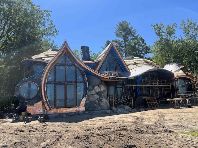 9554 Fowler Ln, Rapid City, MI 49676 - rear view of house featuring a chimney
