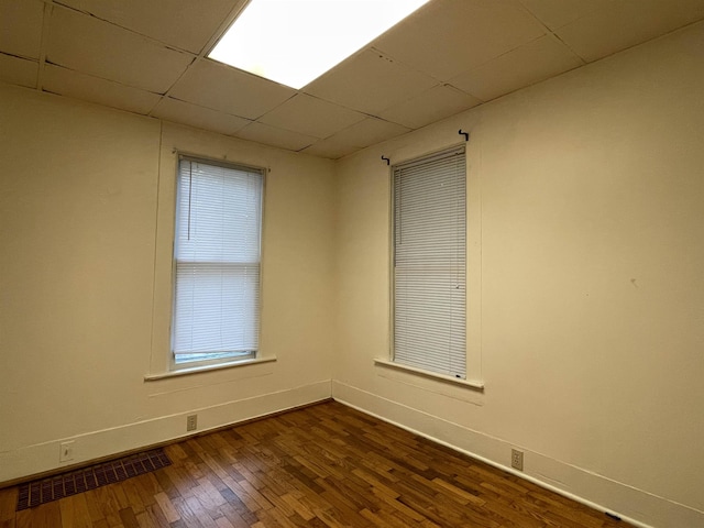 415 S Franklin, Mount Pleasant, MI 48858 - unfurnished room with baseboards, dark wood-style floors, and a drop ceiling