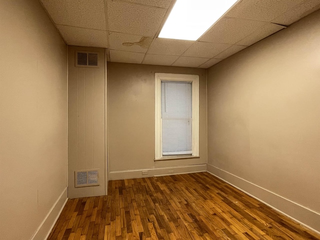 415 S Franklin, Mount Pleasant, MI 48858 - unfurnished room with dark wood-type flooring, baseboards, and a paneled ceiling