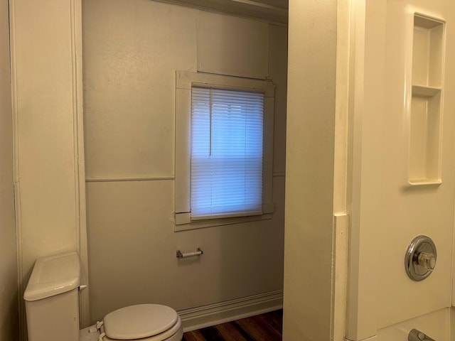 415 S Franklin, Mount Pleasant, MI 48858 - bathroom featuring toilet, wood finished floors, and shower / tub combination