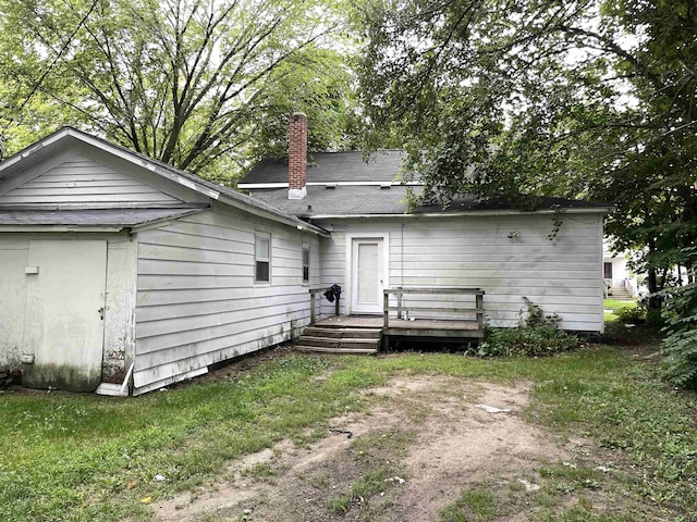 415 S Franklin, Mount Pleasant, MI 48858 - rear view of property with a chimney and a wooden deck