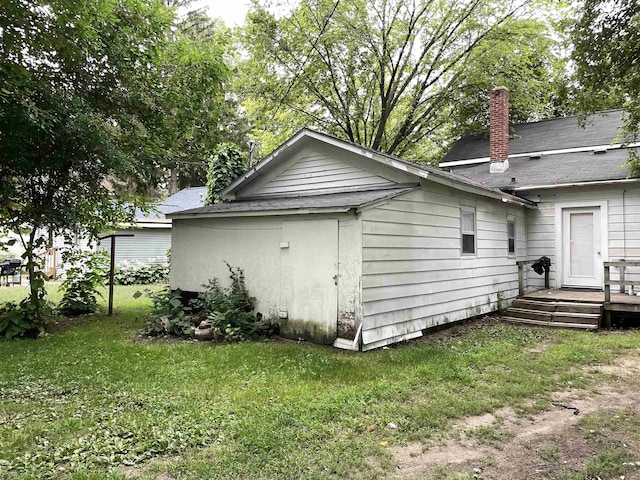 415 S Franklin, Mount Pleasant, MI 48858 - view of property exterior featuring a chimney and a yard