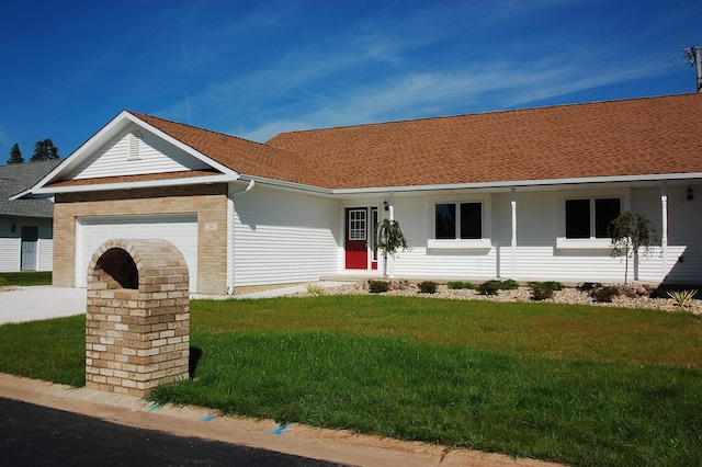 single story home featuring a front lawn and a garage