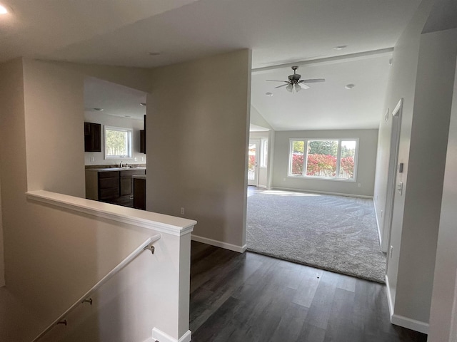 260 Windemere Pl, West Branch, MI 48661 - hall featuring dark wood-type flooring, plenty of natural light, baseboards, an upstairs landing, and vaulted ceiling