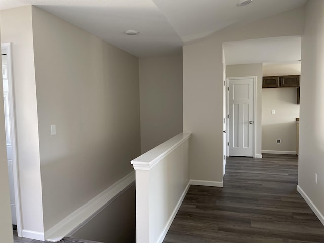 260 Windemere Pl, West Branch, MI 48661 - hallway with an upstairs landing, dark wood finished floors, and baseboards