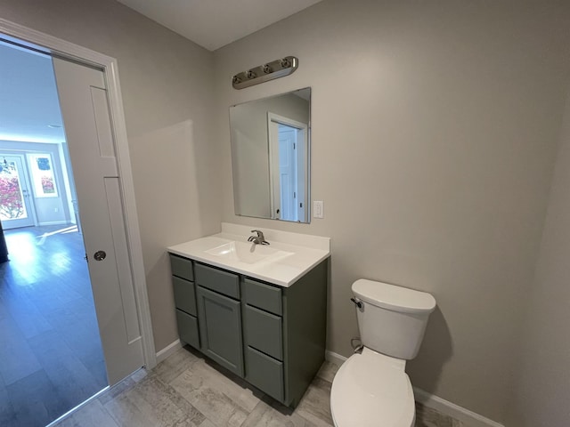 260 Windemere Pl, West Branch, MI 48661 - bathroom with vanity, toilet, and baseboards