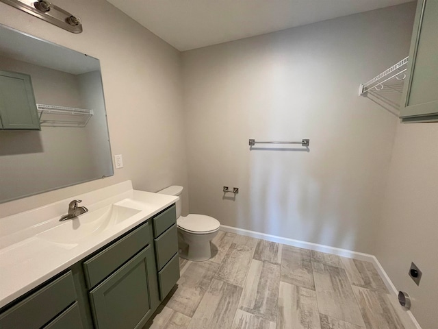 bathroom featuring hardwood / wood-style floors, vanity, and toilet