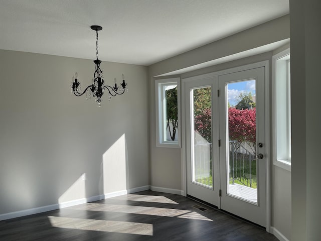 260 Windemere Pl, West Branch, MI 48661 - doorway with a chandelier, dark wood-style flooring, and baseboards