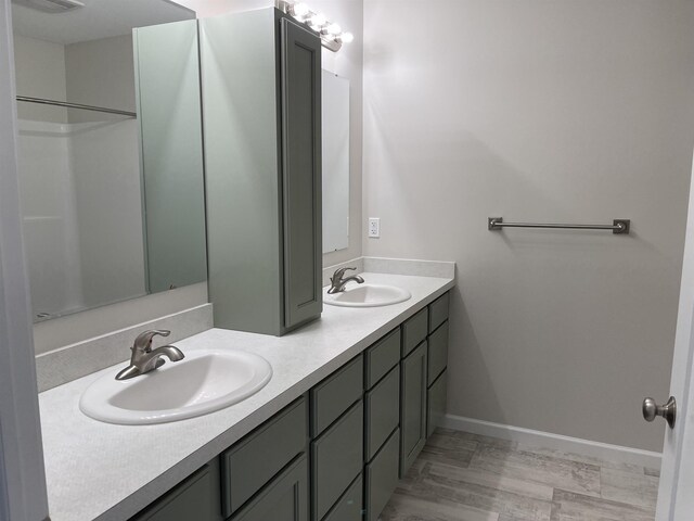 260 Windemere Pl, West Branch, MI 48661 - bathroom featuring double vanity and baseboards