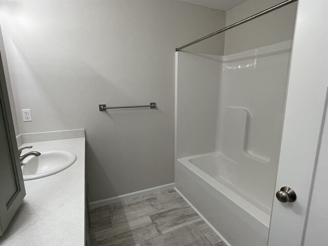 260 Windemere Pl, West Branch, MI 48661 - bathroom with vanity, shower / tub combination, and baseboards