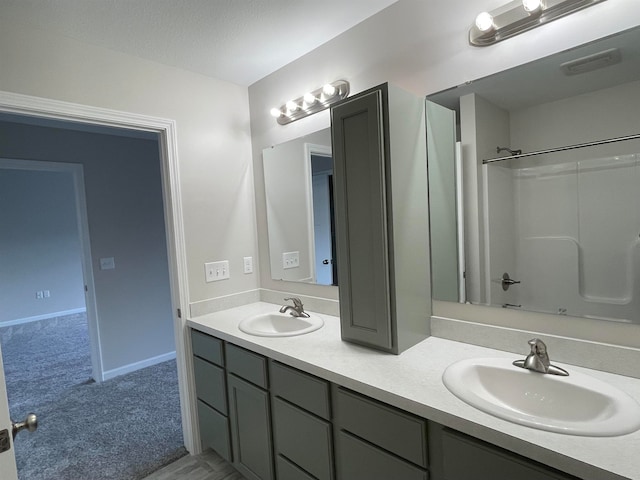 bathroom featuring vanity and  shower combination