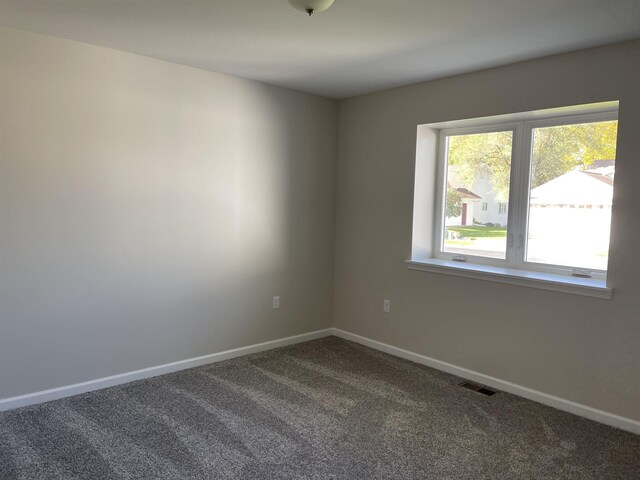 260 Windemere Pl, West Branch, MI 48661 - spare room featuring dark colored carpet and baseboards