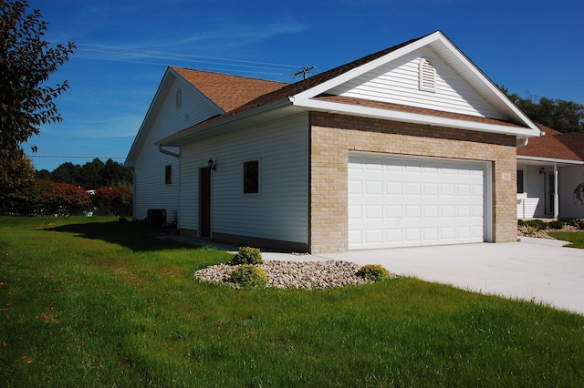 view of side of home with a lawn and a garage