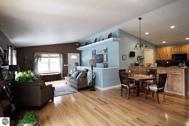 00 Sockeye Dr, Farwell, MI 48622 - living room with lofted ceiling, light wood-type flooring, recessed lighting, baseboards, and a chandelier