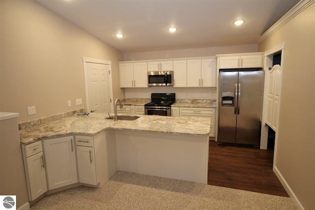 00 Sockeye Dr, Farwell, MI 48622 - kitchen with stainless steel appliances, a sink, a peninsula, white cabinets, and recessed lighting