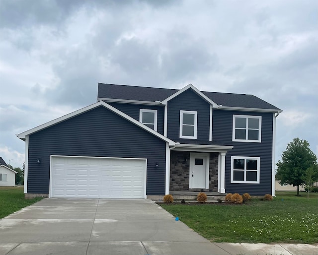 view of front of home featuring a front yard and a garage