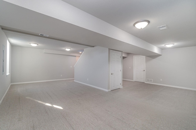 basement featuring light colored carpet