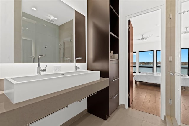 bathroom with walk in shower, vanity, ceiling fan, wood-type flooring, and a water view