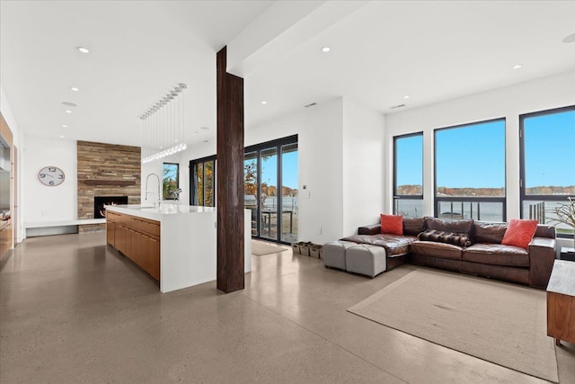 living room with a large fireplace and a water view