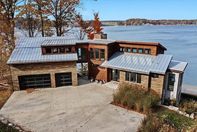 view of front of home featuring a water view and a garage