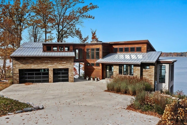 view of front of property featuring a water view and a garage