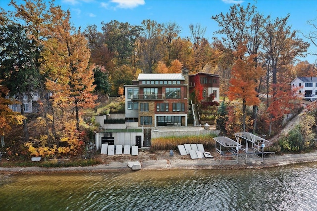 back of property featuring a water view