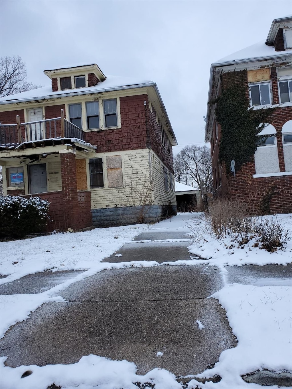 view of snowy exterior with a balcony