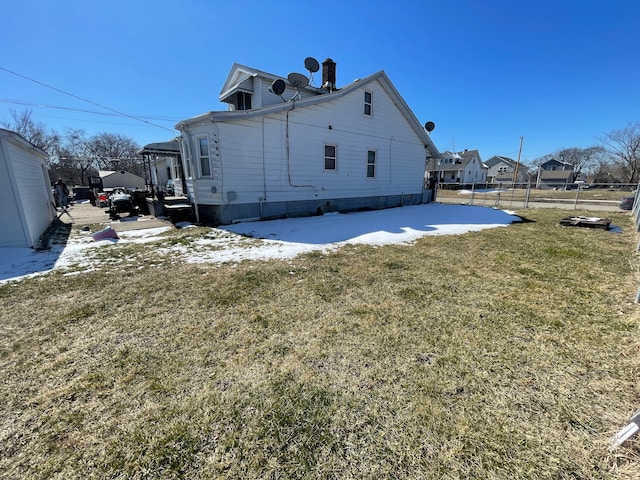 view of side of home featuring a yard