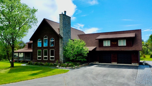 log cabin with a garage and a front yard