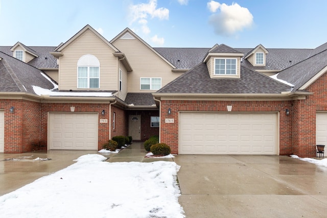176 Sea Breeze Dr Unit 6, Detroit, MI 48214 - view of front of home featuring concrete driveway, brick siding, and a shingled roof