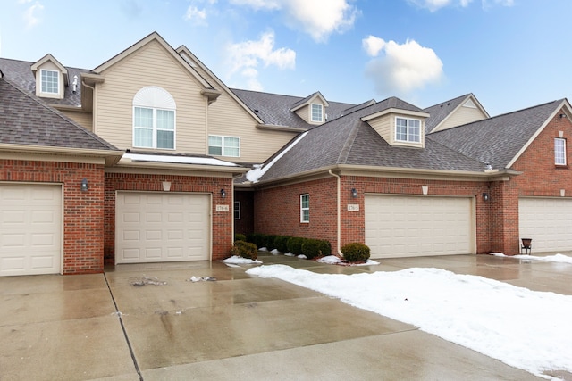 176 Sea Breeze Dr Unit 6, Detroit, MI 48214 - view of front of property with brick siding, roof with shingles, driveway, and a garage