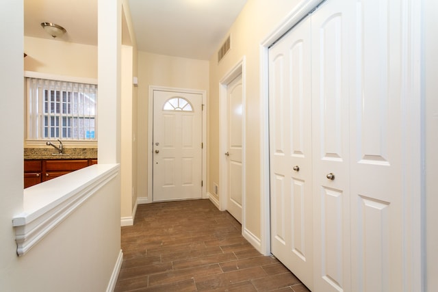 176 Sea Breeze Dr Unit 6, Detroit, MI 48214 - entryway featuring dark wood-style floors and baseboards