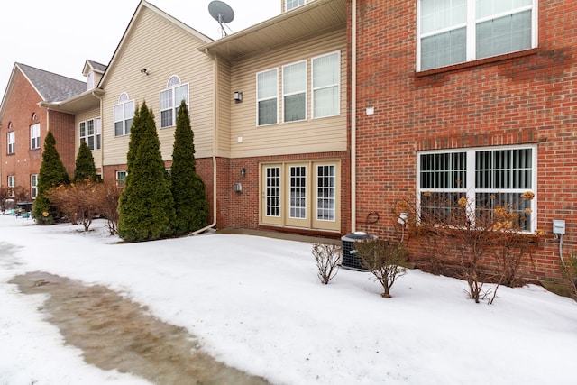 176 Sea Breeze Dr Unit 6, Detroit, MI 48214 - snow covered back of property with brick siding and central AC