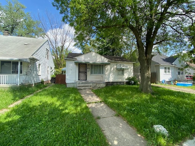 bungalow-style house with a front yard