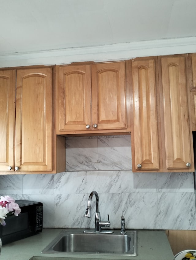 kitchen featuring decorative backsplash and sink