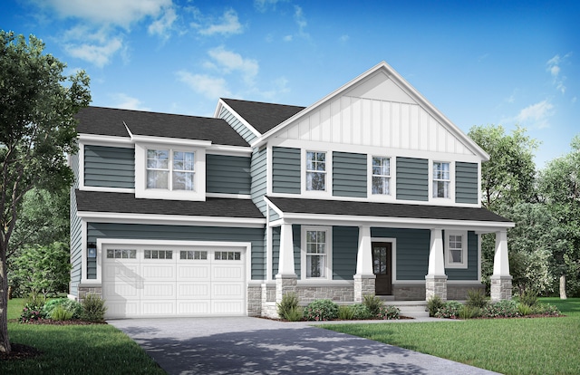 view of front of house featuring covered porch, a garage, and a front lawn