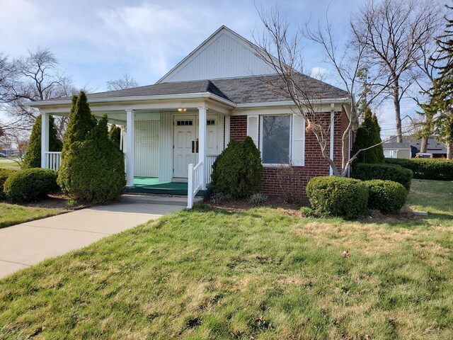 20331 Outer Dr, Dearborn, MI 48124 - bungalow-style home with brick siding, a porch, a front yard, and a shingled roof