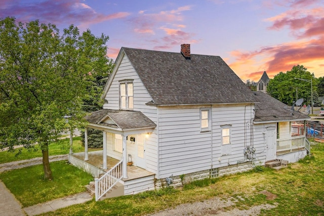 19 Stanton St, Oxford, MI 48371 - view of home's exterior featuring a porch, a chimney, a shingled roof, and a yard