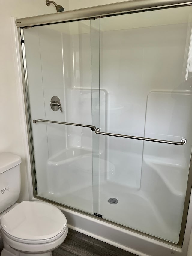 3075 Waukegan St, Auburn Hills, MI 48326 - bathroom featuring toilet, a shower stall, and wood finished floors