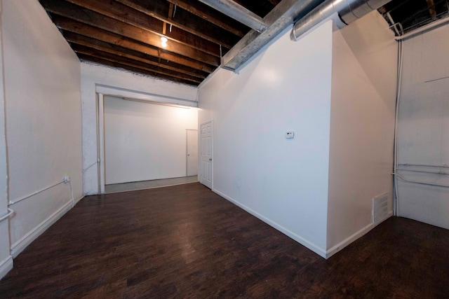 basement featuring dark hardwood / wood-style flooring