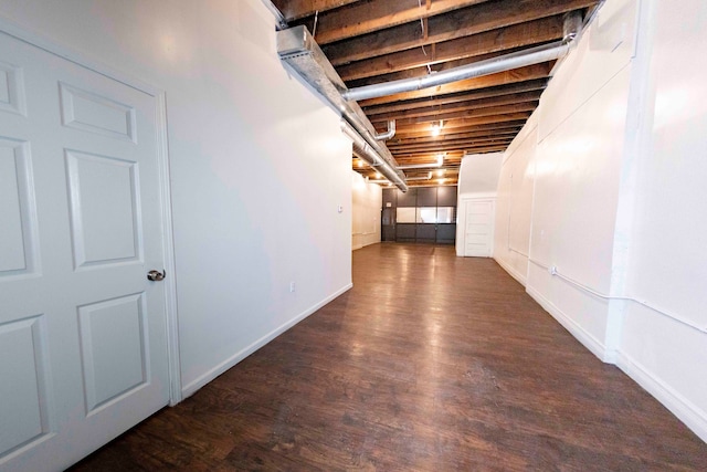 basement featuring dark hardwood / wood-style flooring