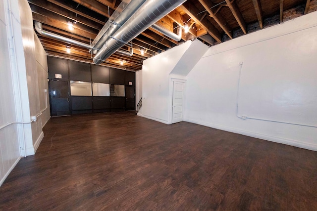 basement featuring dark hardwood / wood-style flooring