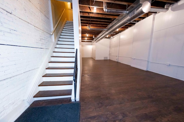 basement with dark hardwood / wood-style floors