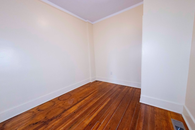 unfurnished room with crown molding and dark wood-type flooring