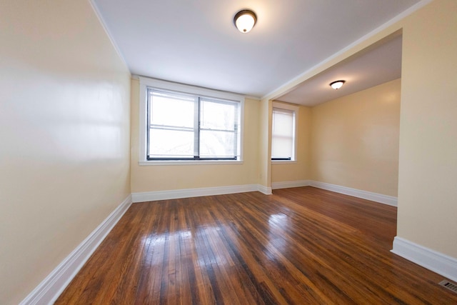 empty room with dark wood-type flooring