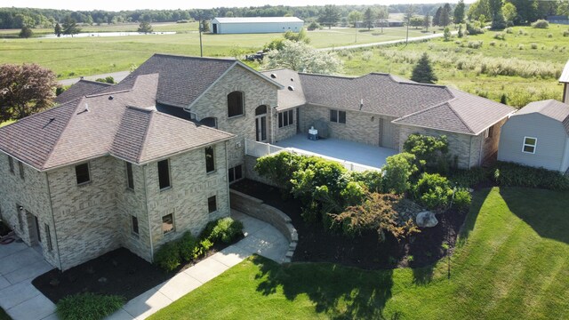 birds eye view of property with a rural view