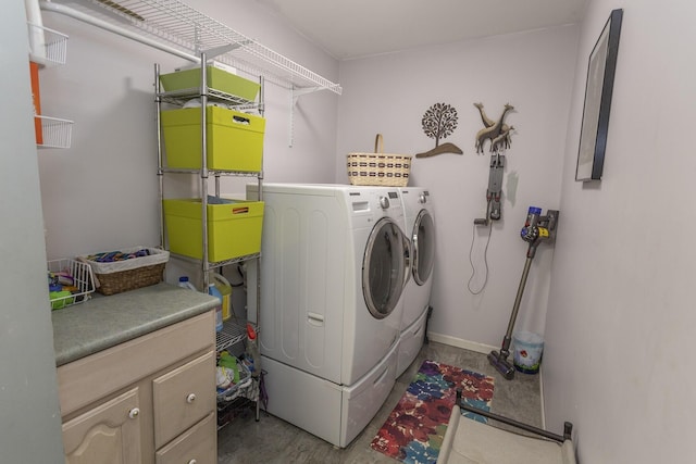 washroom with cabinets and washer and dryer