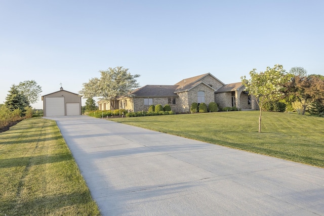 view of front of property with an outdoor structure, a front yard, and a garage