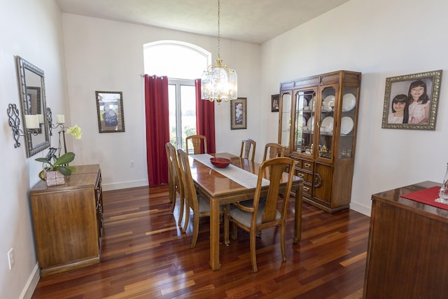 dining area featuring dark hardwood / wood-style floors and a notable chandelier